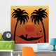 Woman Reading in a Hammock Between Palm Trees Wall Mural
