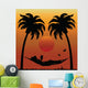Woman Reading in a Hammock Between Palm Trees Wall Mural