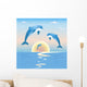 Jumping dolphins in front of a sunset over sea Wall Mural