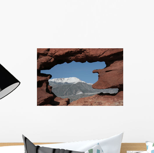 Pikes Peak mountain as seen through a hole in red rocks at Garde Wall Mural