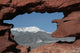 Pikes Peak mountain as seen through a hole in red rocks at Garde Wall Mural