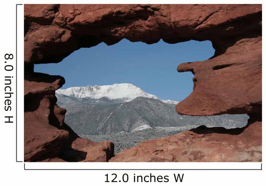 Pikes Peak mountain as seen through a hole in red rocks at Garde Wall Mural
