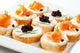 Mini sandwiches - bagel with cream cheese, salmon, caviar Wall Mural