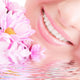 Smile of Young Woman With Flowers Wall Mural