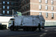 garbage truck emptying dumpsters Wall Mural