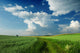 Beautiful Clouds over green fields Wall Mural