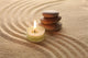 Stack of Pebbles and Light Candle Wall Mural