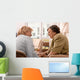 Senior woman is visited  by her doctor or caregiver at home Wall Mural