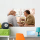 Senior woman is visited  by her doctor or caregiver at home Wall Mural