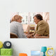 Senior woman is visited  by her doctor or caregiver at home Wall Mural