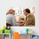 Senior woman is visited  by her doctor or caregiver at home Wall Mural