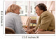 Senior woman is visited  by her doctor or caregiver at home Wall Mural