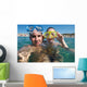 Lovely couple enjoying snorkeling during their vacation Wall Mural