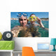 Lovely couple enjoying snorkeling during their vacation Wall Mural
