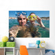 Lovely couple enjoying snorkeling during their vacation Wall Mural