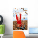 happy seven year old girl playing in pile of leave Wall Mural