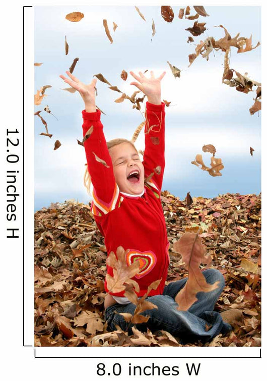 happy seven year old girl playing in pile of leave Wall Mural