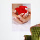 Woman hands with french manicure holding red rose Wall Mural