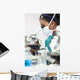 Asian Woman Doctor or Scientist Using a Microscope In Laboratory Wall Mural