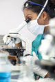 Asian Woman Doctor or Scientist Using a Microscope In Laboratory Wall Mural