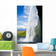 waterfall in a green landscape in Iceland Wall Mural