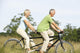 Mature couple riding tandem Wall Mural