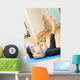 Young happy woman exercising with expander at home Wall Mural