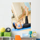Young happy woman exercising with expander at home Wall Mural