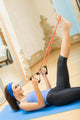 Young happy woman exercising with expander at home Wall Mural