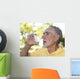 Elderly man using asthma inhaler outdoors Wall Mural