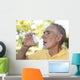 Elderly man using asthma inhaler outdoors Wall Mural