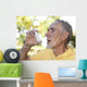 Elderly man using asthma inhaler outdoors Wall Mural