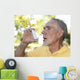 Elderly man using asthma inhaler outdoors Wall Mural