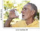 Elderly man using asthma inhaler outdoors Wall Mural