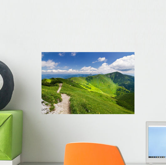 Mountain-ridge and blue sky with white clouds Wall Mural