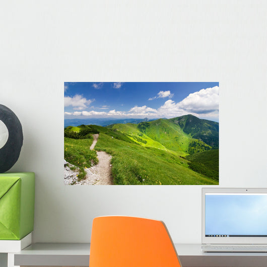 Mountain-ridge and blue sky with white clouds Wall Mural