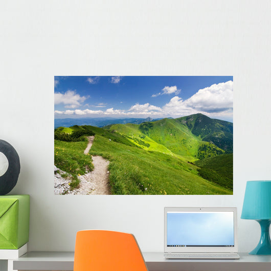 Mountain-ridge and blue sky with white clouds Wall Mural