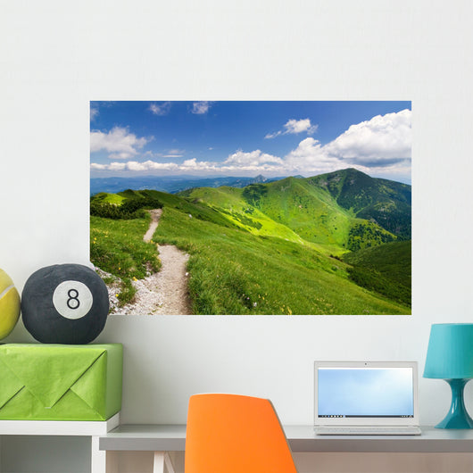 Mountain-ridge and blue sky with white clouds Wall Mural