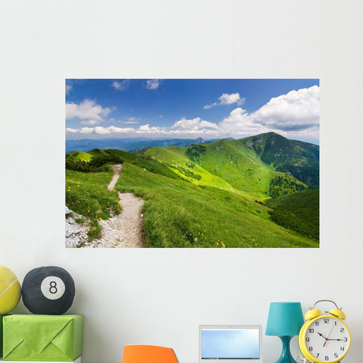 Mountain-ridge and blue sky with white clouds Wall Mural