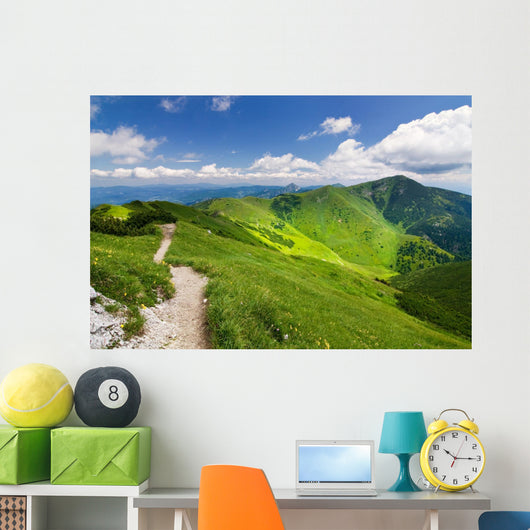 Mountain-ridge and blue sky with white clouds Wall Mural