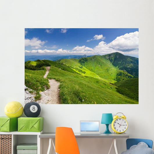 Mountain-ridge and blue sky with white clouds Wall Mural