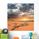 dried up branch in a desert before a sunset Wall Mural