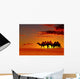 Desert landscape with walking camels at sunset Wall Mural