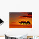 Desert landscape with walking camels at sunset Wall Mural