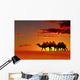 Desert landscape with walking camels at sunset Wall Mural