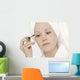 Woman Applying Mascara Wall Mural