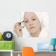 Woman Applying Mascara Wall Mural