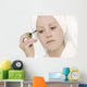 Woman Applying Mascara Wall Mural