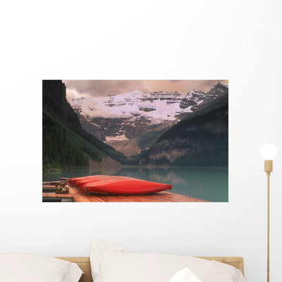 Canoes Lined Dock Wall Mural shown on a wall