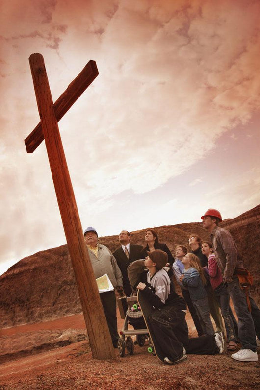 A Small Crowd Gathered At A Wooden Cross Wall Mural